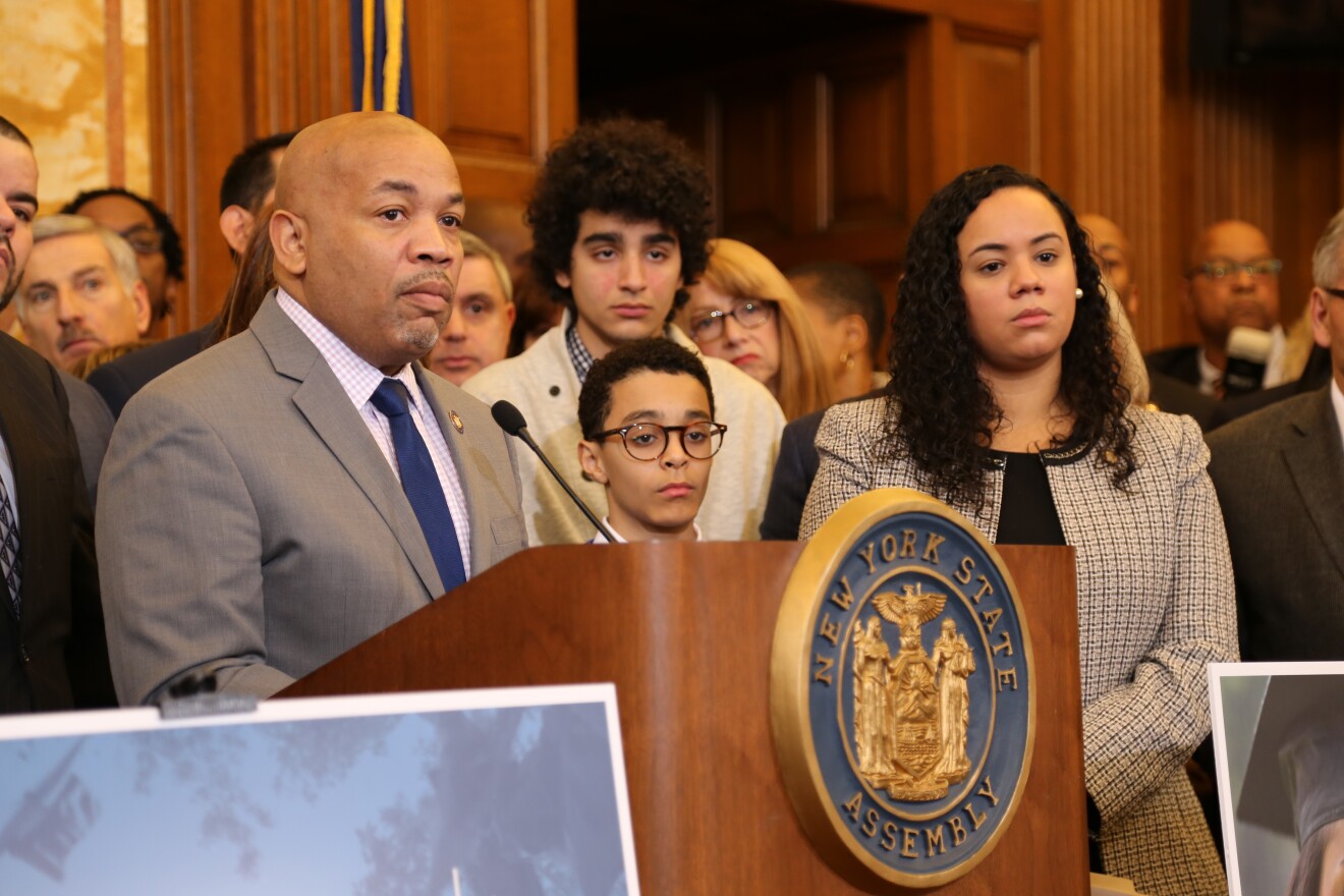 Assembly Speaker Carl Heastie speaks just before the Assembly approved the Dream Act on Wednesday. Family members of the late Sen. Jose Peralta, who was a champion of the measure, looks on. Assembly sponsor Carmen De La Rosa is on the right.  